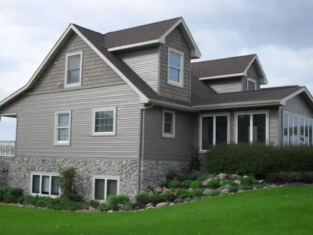 A large home with new, gray siding