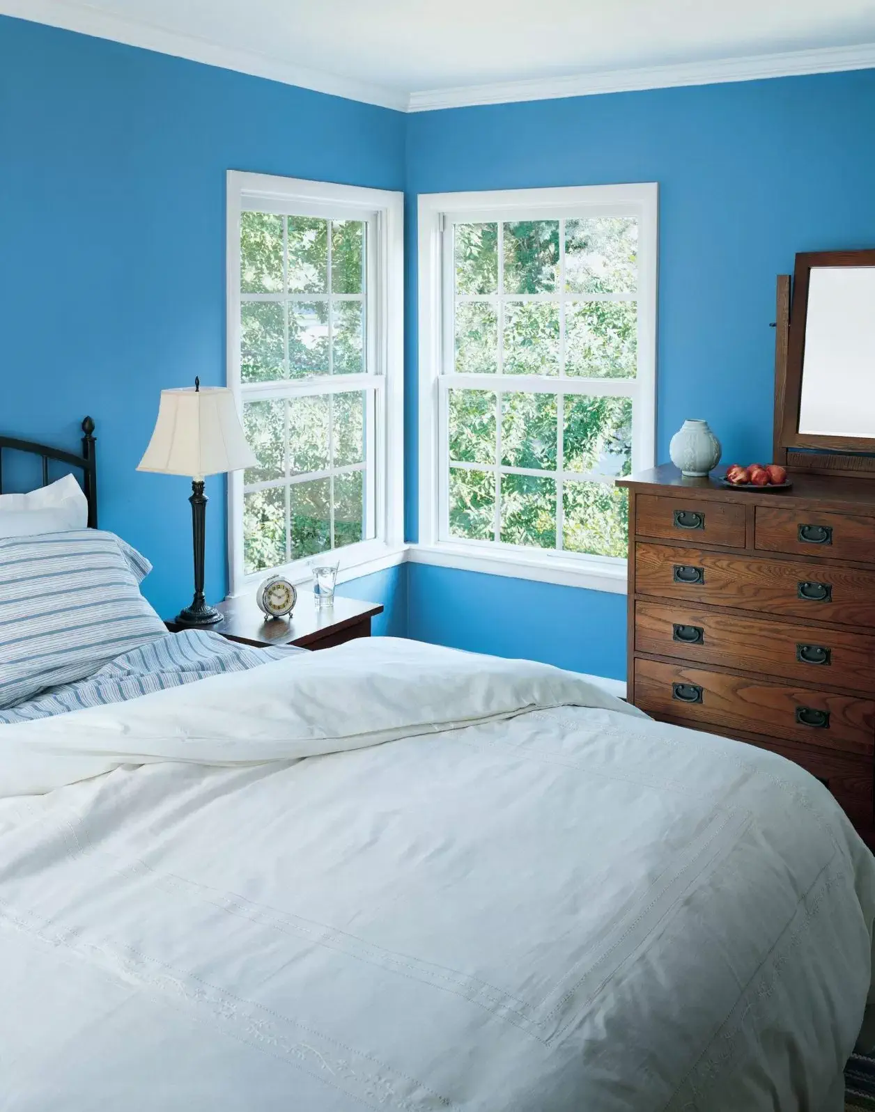 Bedroom with blue walls and large window