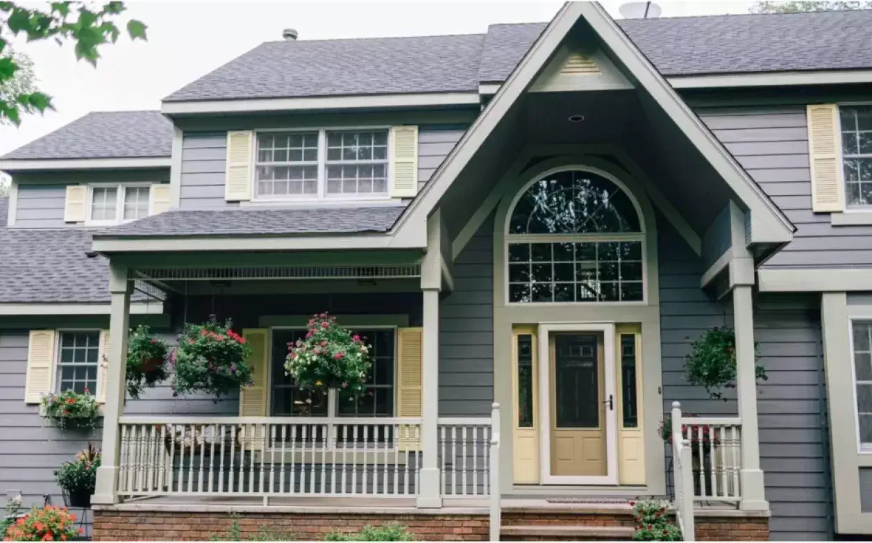Craftsman-style home with arched entry and landscaping