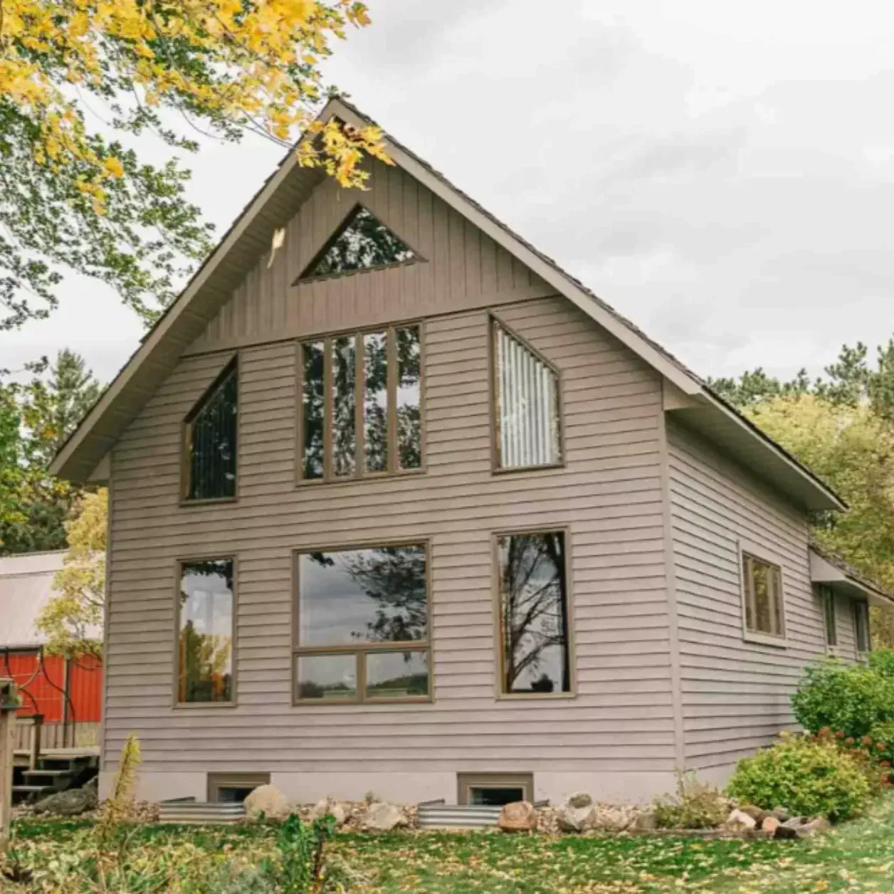 Two-story home with light siding and gable roof
